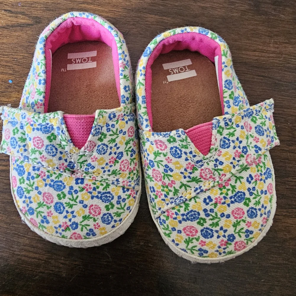 3 pairs of baby/girl shoes—soft, floral, and glittery—in various styles.